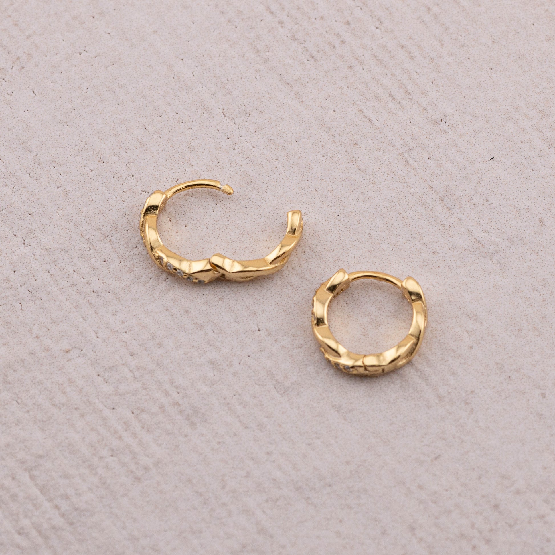 Close-up of hinged closure on 9mm twisted huggie hoop, demonstrating how it opens and closes securely.