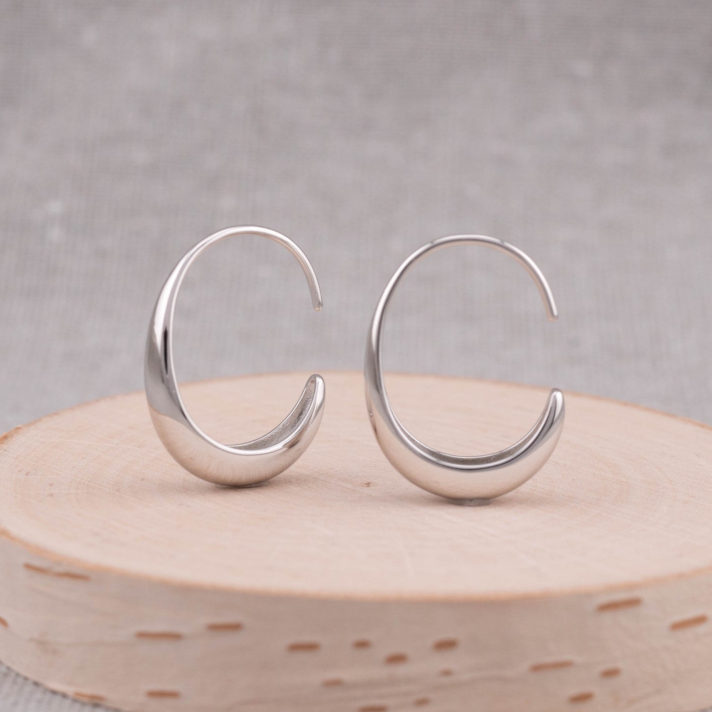 Small thick silver hoops earrings front side showing its trendy earring shape