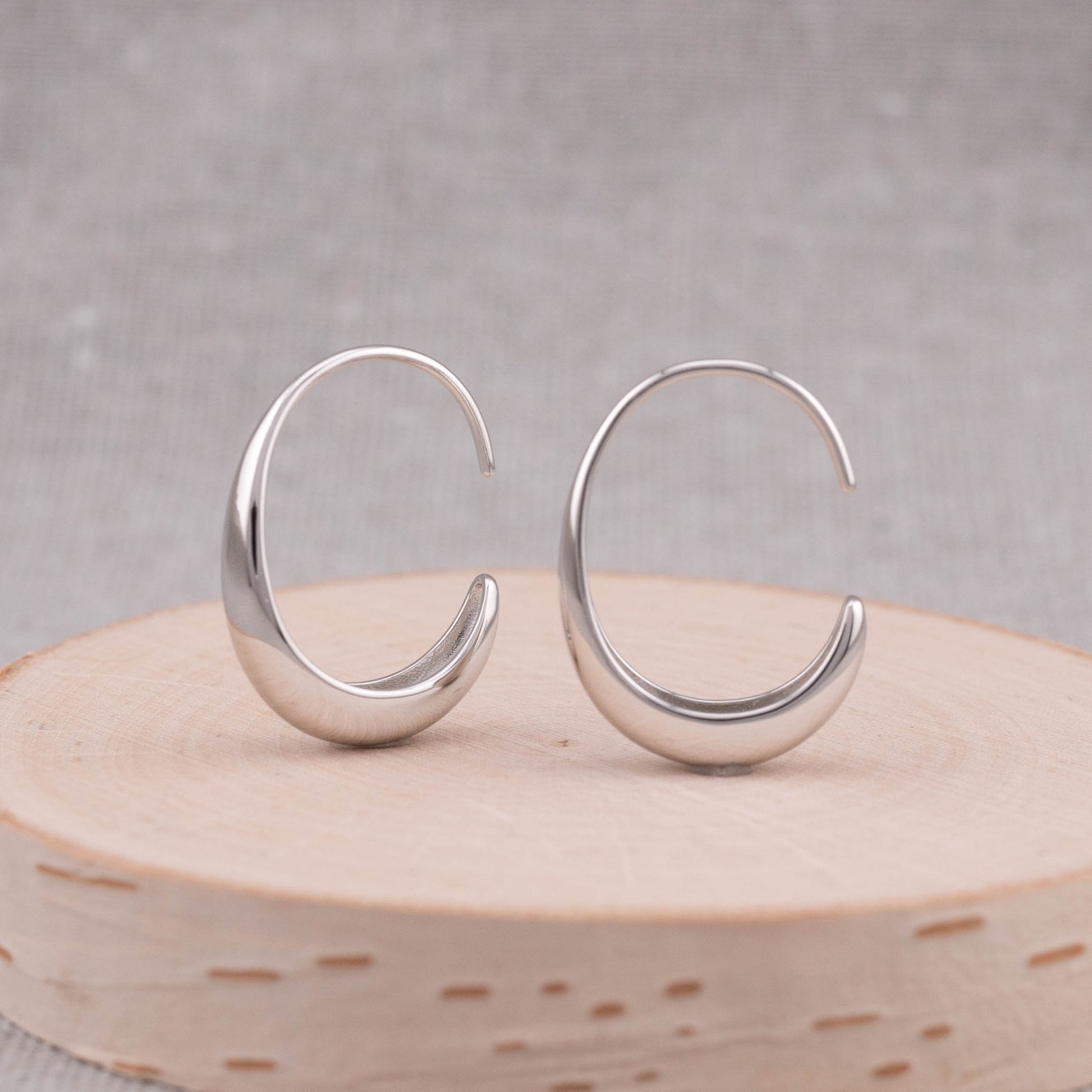 Small thick silver hoops earrings front side showing its trendy earring shape