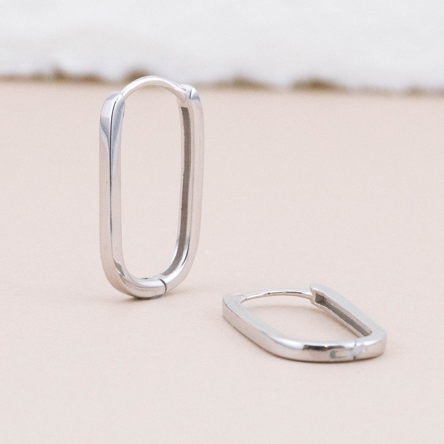Sterling silver endless hoop earrings - displayed upright and lying flat, showcasing classic angles and design detail