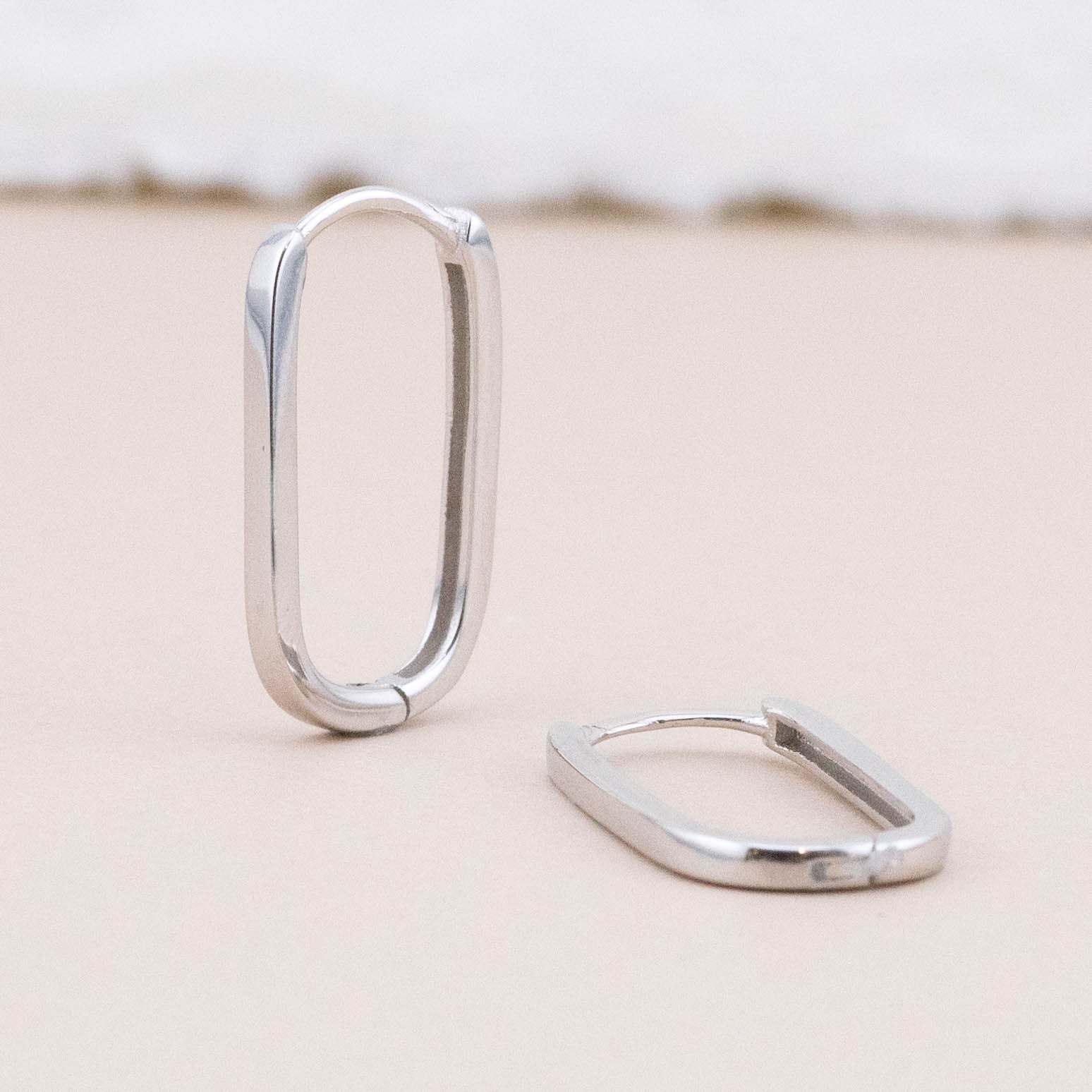 Sterling silver endless hoop earrings - displayed upright and lying flat, showcasing classic angles and design detail