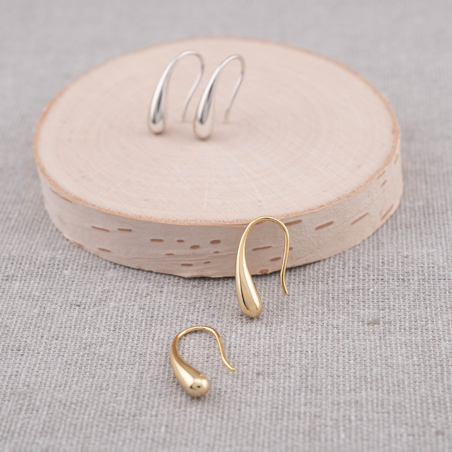 small drop earrings gold and silver staged to show available finish