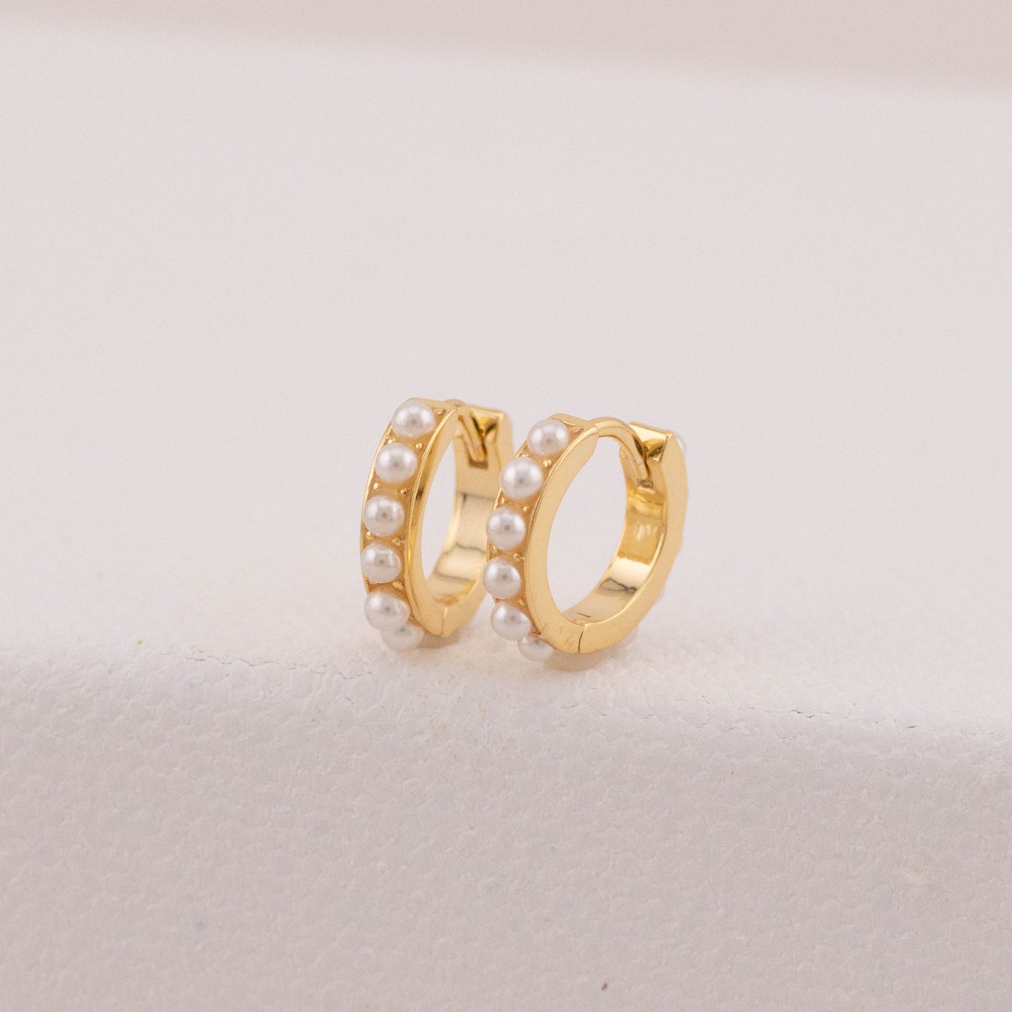 Tarnish-free earrings in gold with tiny pearls, highlighting their clean, bright finish.