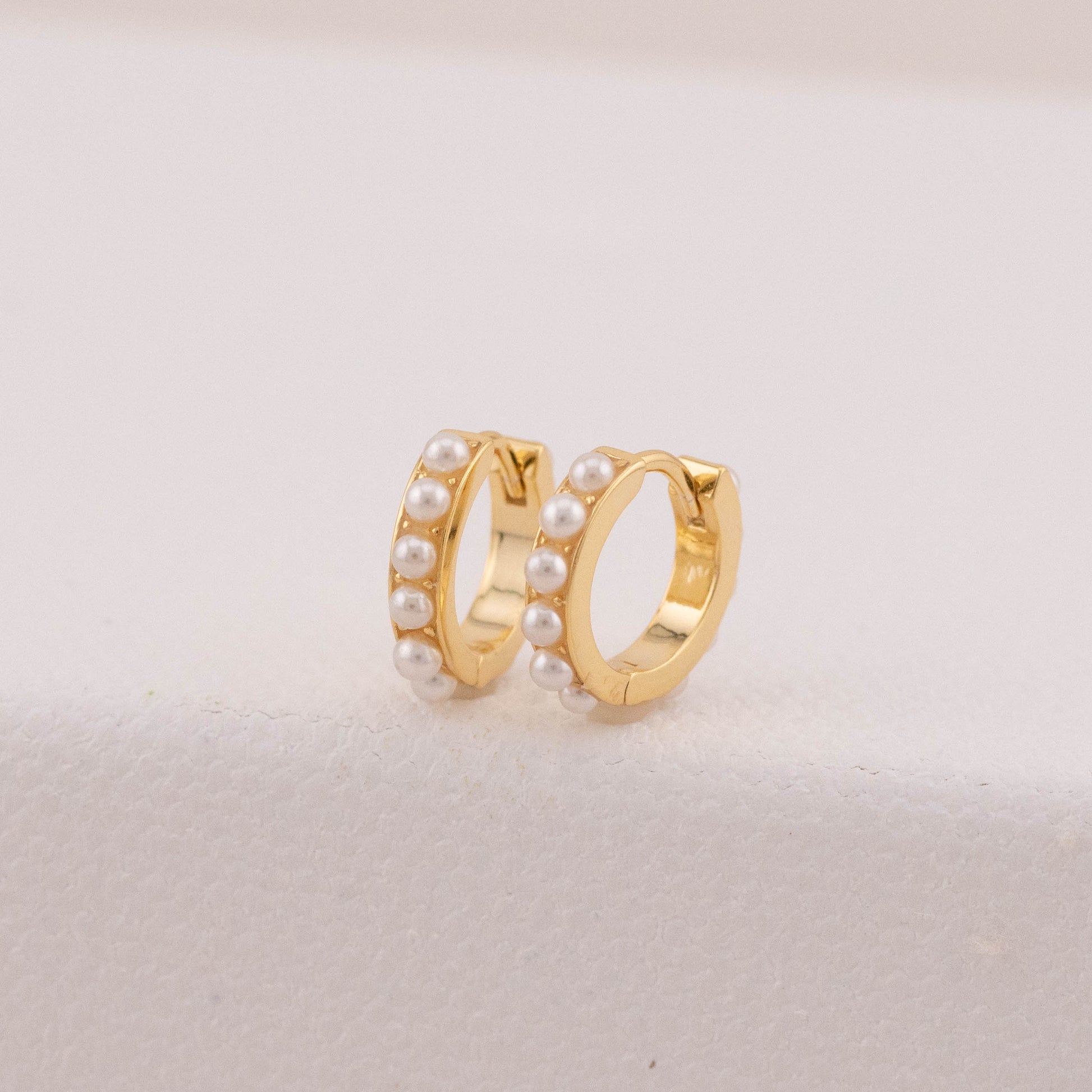 Tarnish-free earrings in gold with tiny pearls, highlighting their clean, bright finish.