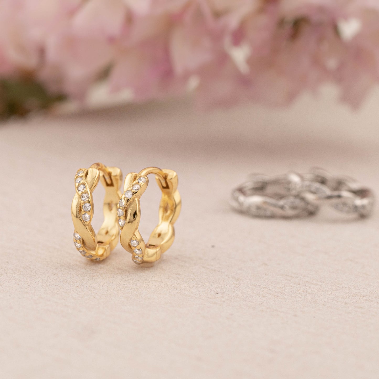 Side view of 9mm twisted huggie hoop in sterling silver and 14K gold vermeil, highlighting the delicate texture and sleek, minimal style.