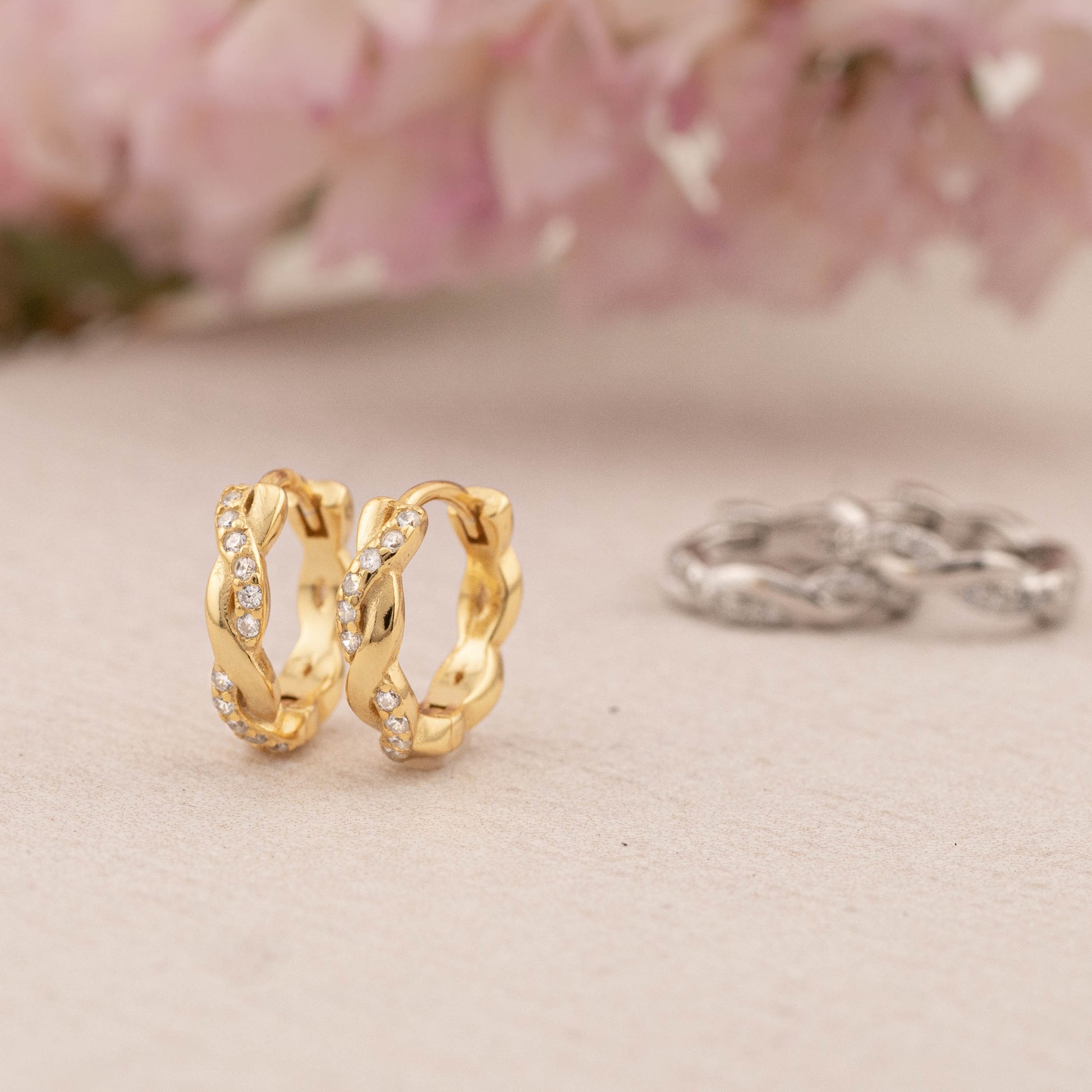 Side view of 9mm twisted huggie hoop in sterling silver and 14K gold vermeil, highlighting the delicate texture and sleek, minimal style.