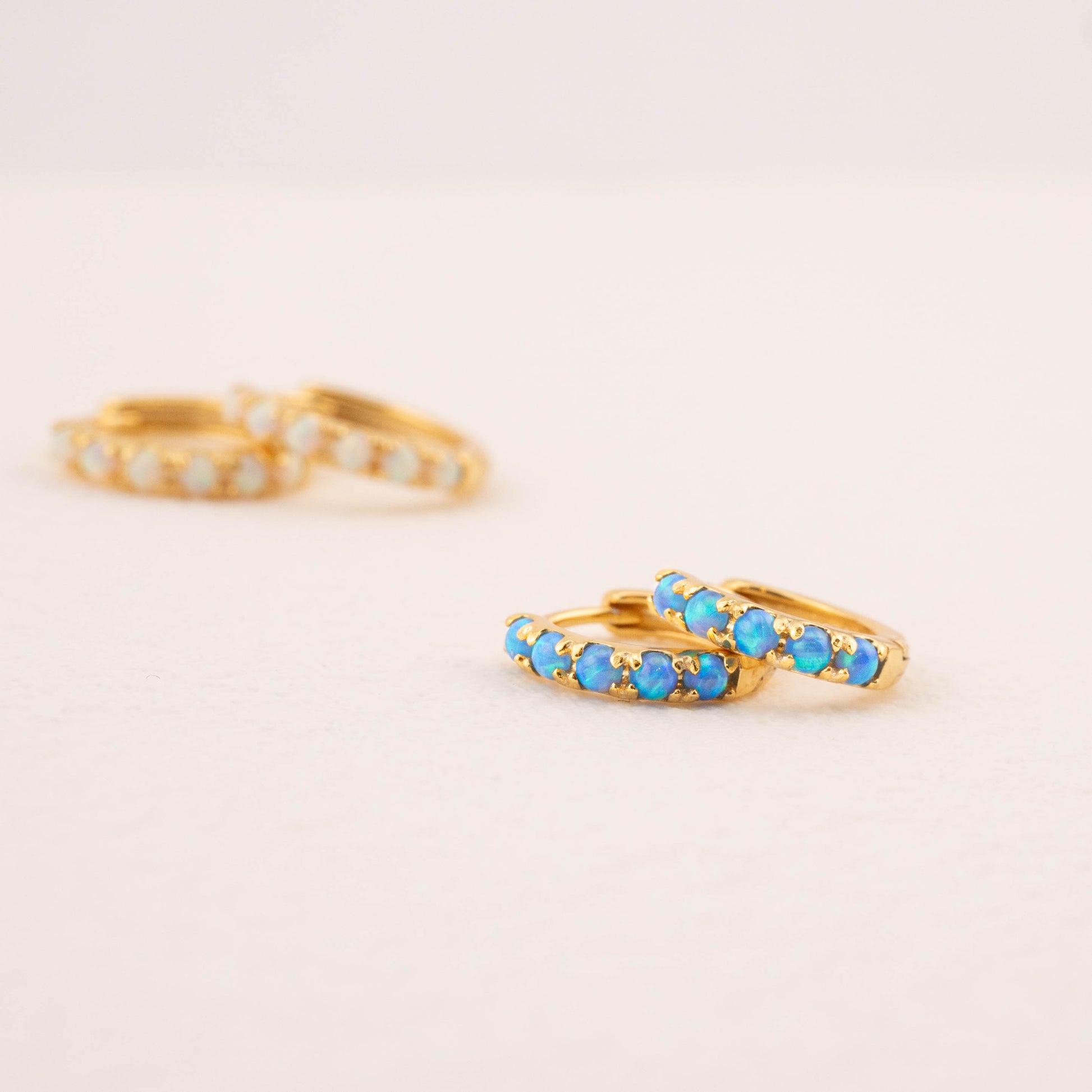 Close-up of blue opal earrings, highlighting their vibrant color and detail.