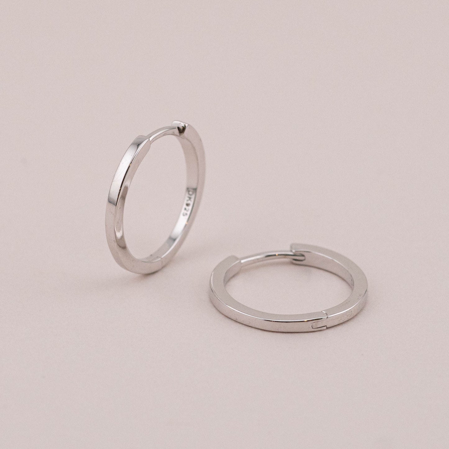 Silver sleepers hoop with hinged closure, staged to show thickness and closure detail.
