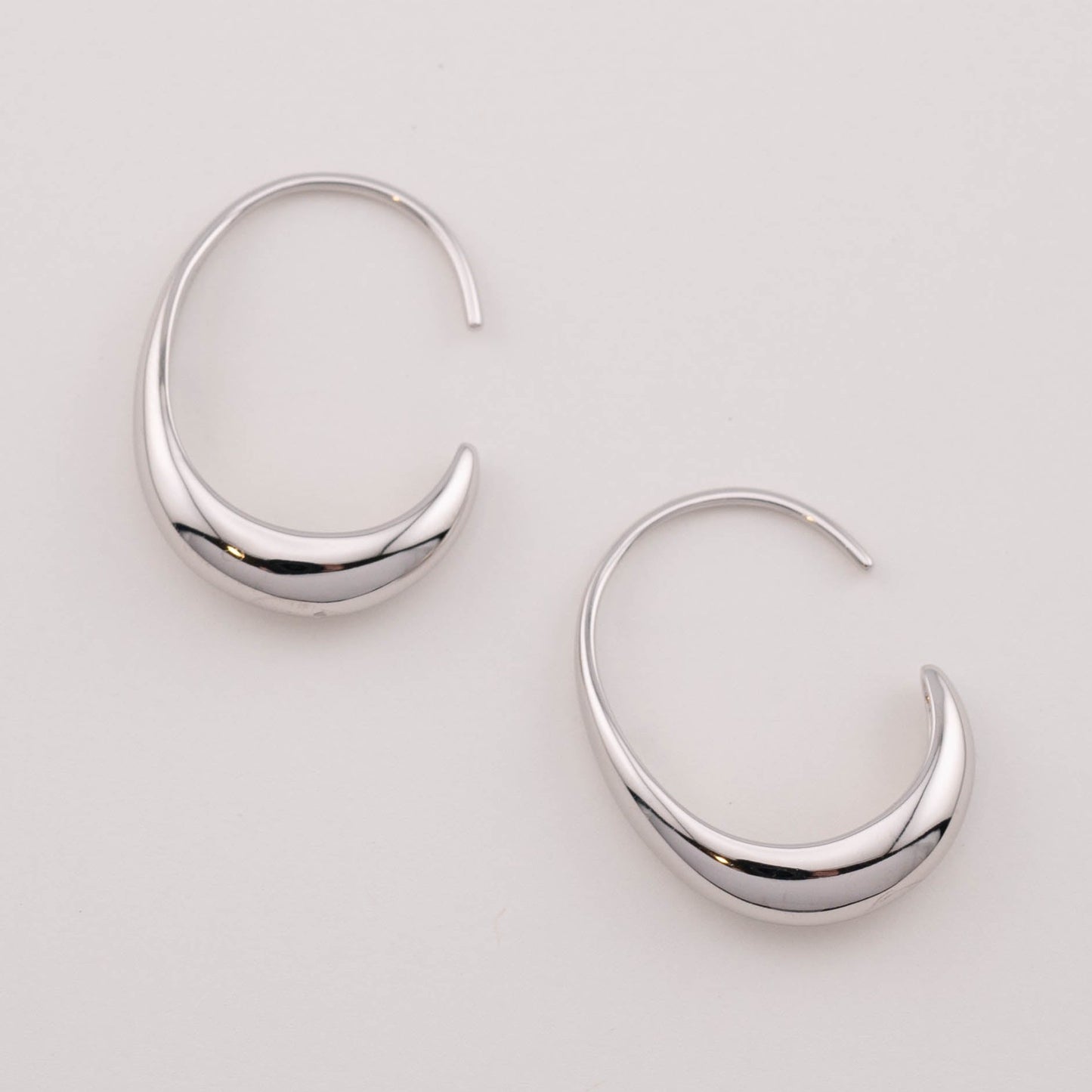 Minimalist medium sized silver ear hoops earrings view from the top