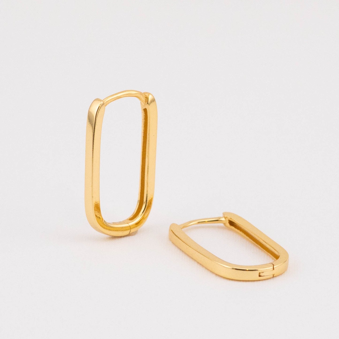 Gold modern earrings, displayed as a pair from the front to show their stylish design and polished finish.