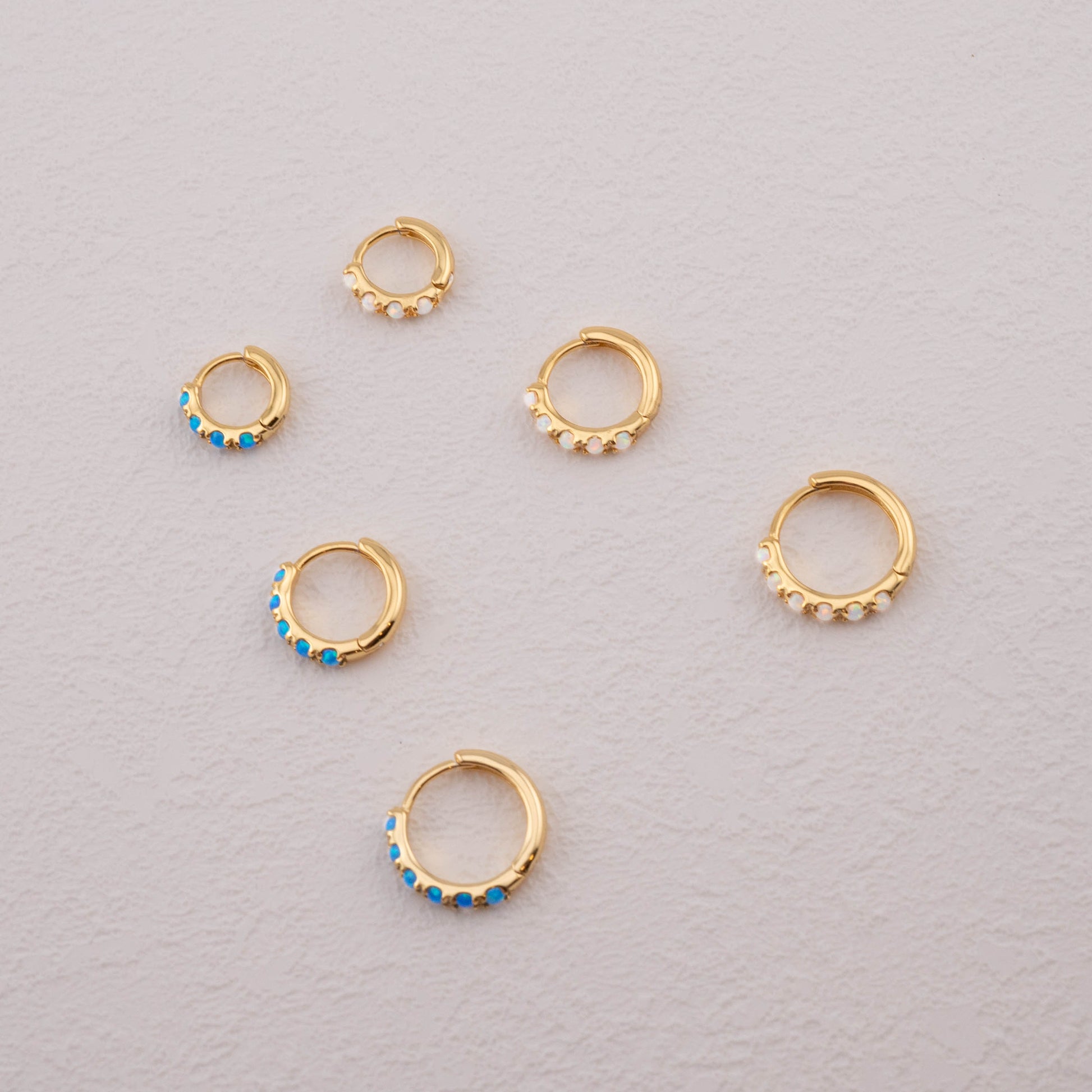 Earrings with opal: blue and white opal in gold, 6mm, 8mm, 10mm, shown from the side.