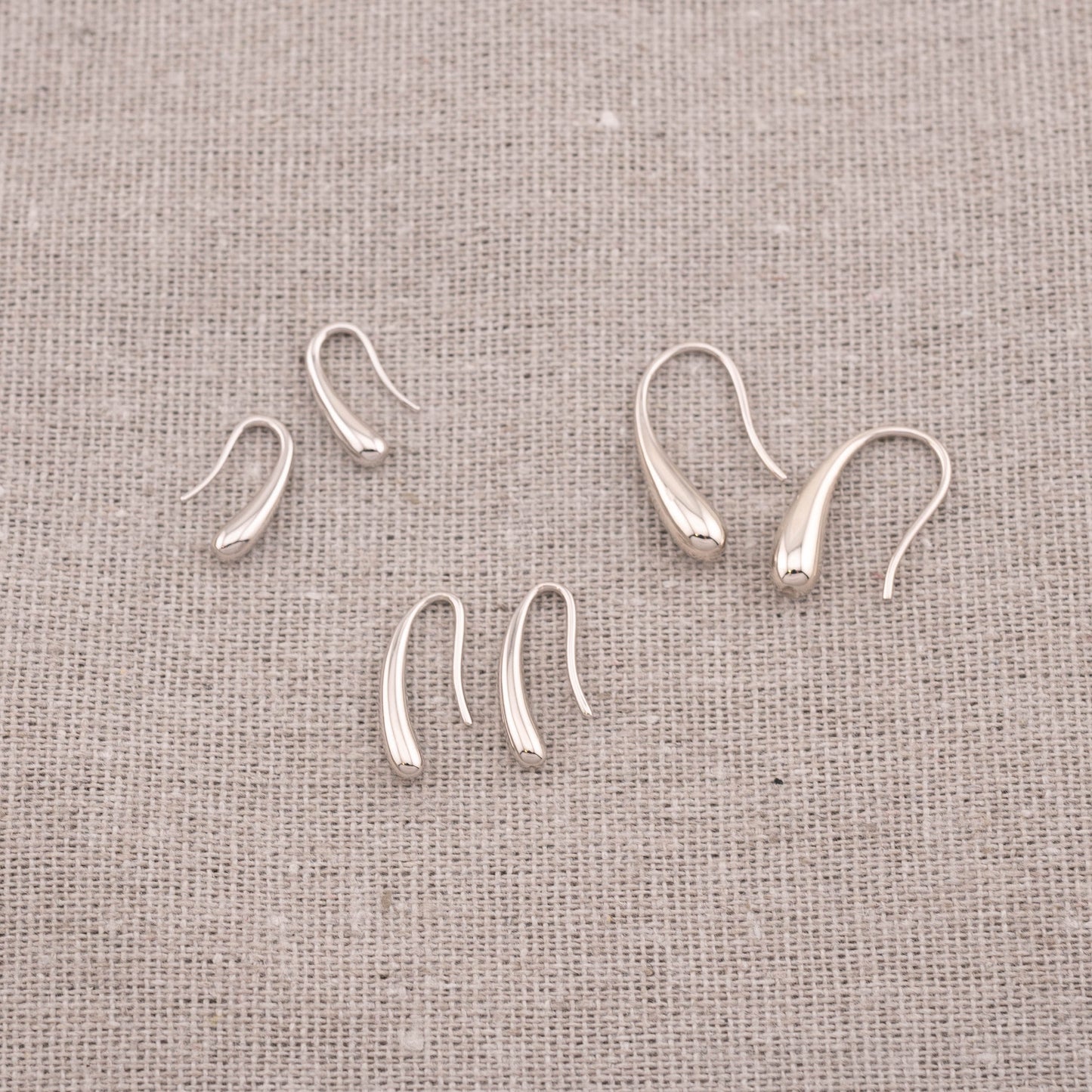 Assorted affordable teardrop earrings in sterling silver and 14K gold vermeil, various sizes.