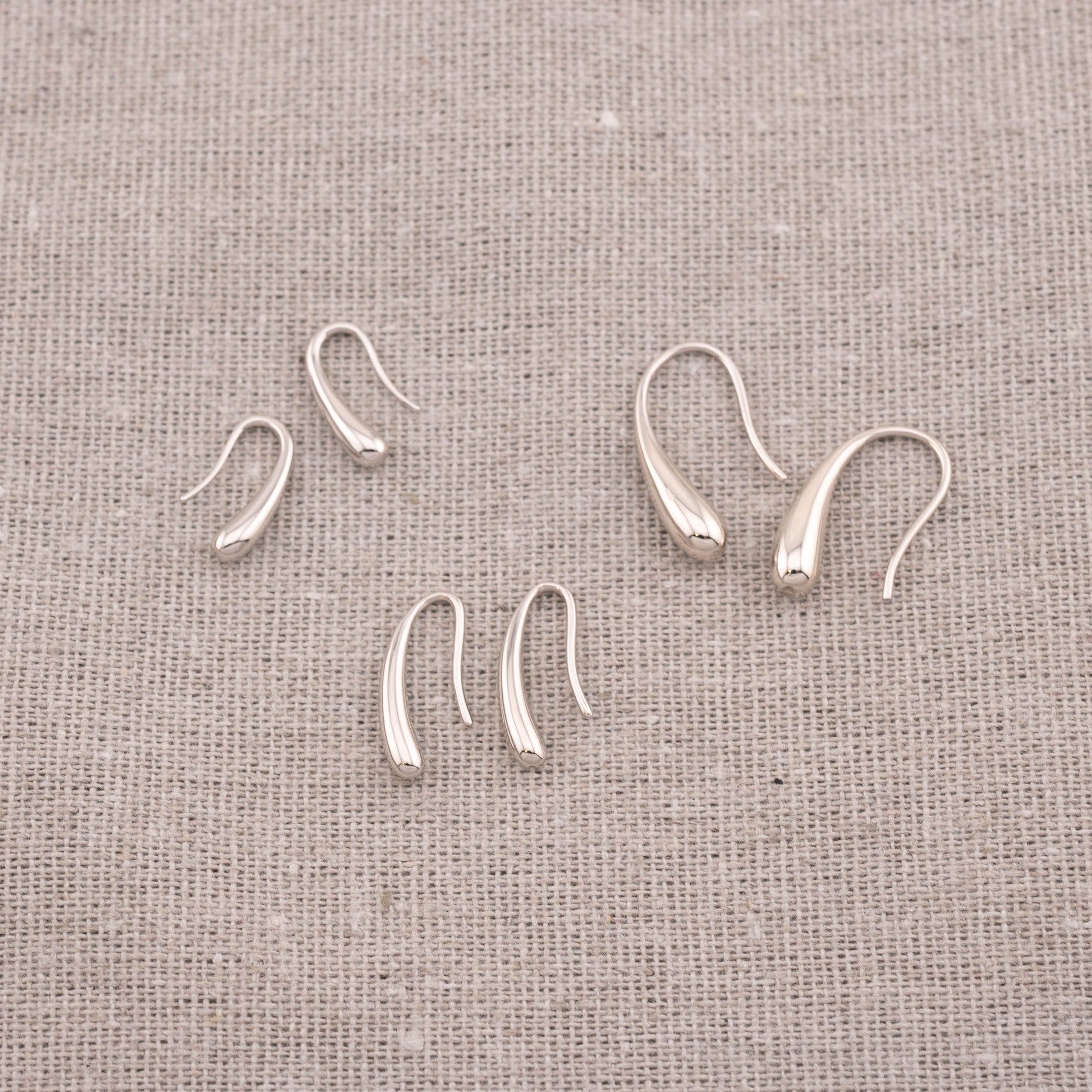 Assorted affordable teardrop earrings in sterling silver and 14K gold vermeil, various sizes.